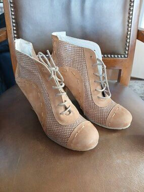 Novel short boot design in contrasting leathers.